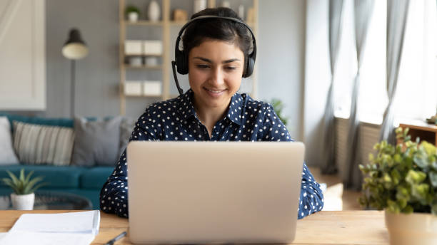 istock Smiling millennial ethnic female watch webinar on computer 1208855997