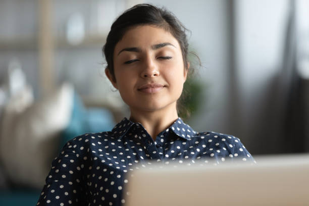 istock Millennial Indian woman relax at workplace taking nap 1208856008