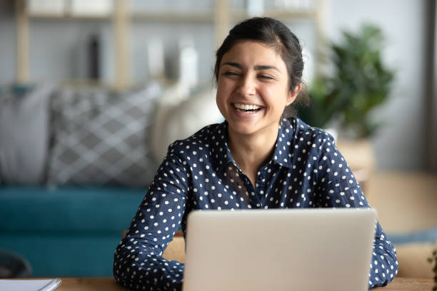 istock Overjoyed indian girl have fun talking with friend 1208856011