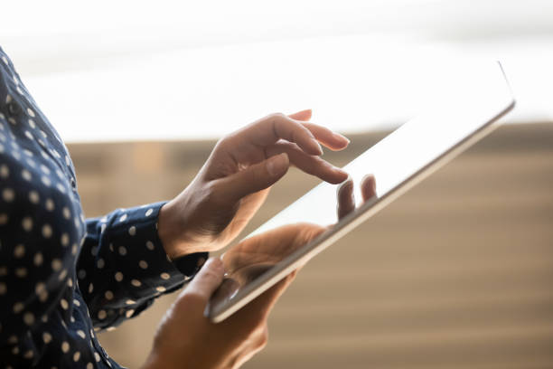 istock Close up of woman using modern tablet gadget 1208856042
