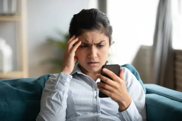 Photo of Frustrated girl feel stressed with cellphone problems