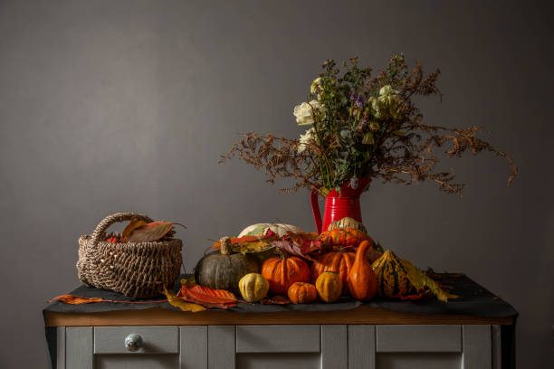 istock pumpkins and squashes with faded flowers 1208859299