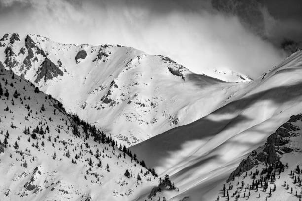istock Snowy B&W mountain top with cloudy sky 1208860460