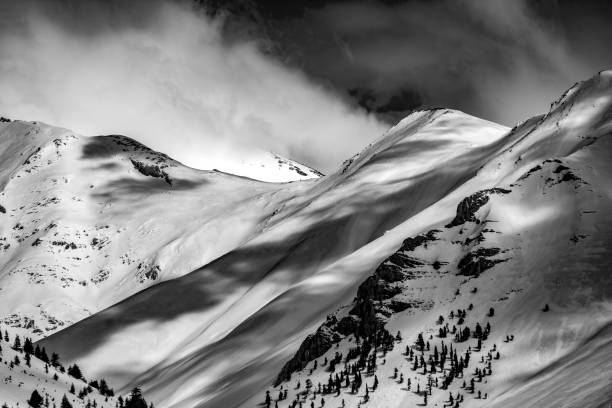 istock Snowy B&W mountain top with cloudy sky 1208860660