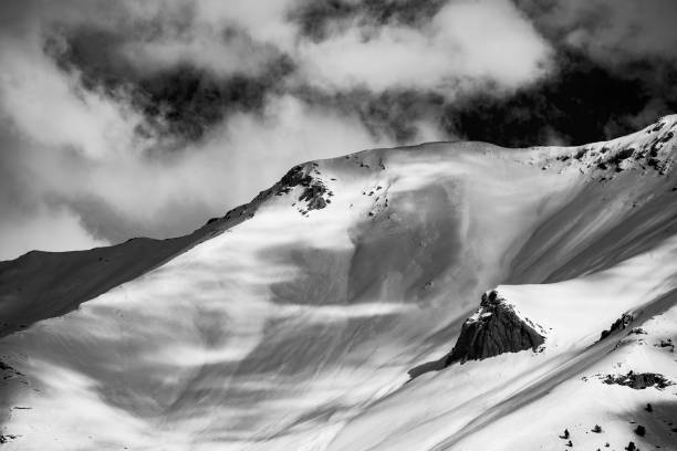 istock Snowy B&W mountain top with cloudy sky 1208861538