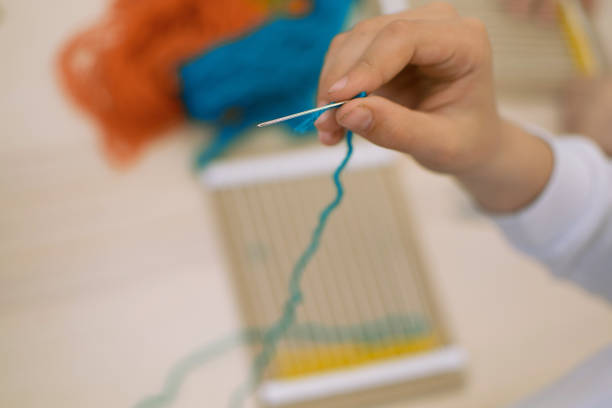 istock Children hands weaving loom in art theraphy class at school 1208865057