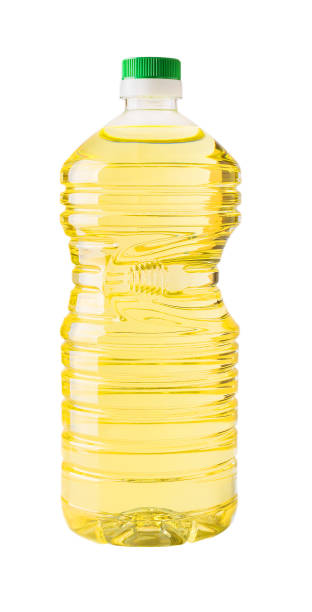 Cooking sunflower or vegetable oil in a 2l transparent plastic bottle with green cap  isolated on white background. Large container with recess for hand. stock photo