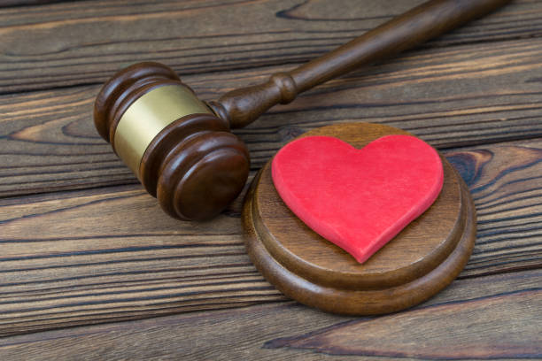 istock Red heart and judge gavel on a wooden table background. 1208866604