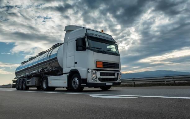 Cistern Tank truck close up on a Highway road Cistern Tank truck close up on a Highway road with a beautiful dramatic sunset sky in the background truck in rain stock pictures, royalty-free photos & images