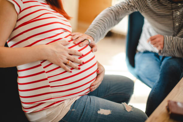 istock Excited future father cuddle his wife's pregnant belly 1208872005