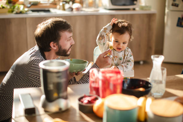istock Angry baby boy refusing to eat his mashed broccoli baby food 1208872162