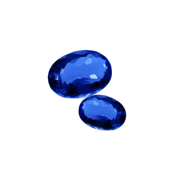 Royal blue kyanite gems on a white background. Natural kyanite oval faceted cut.