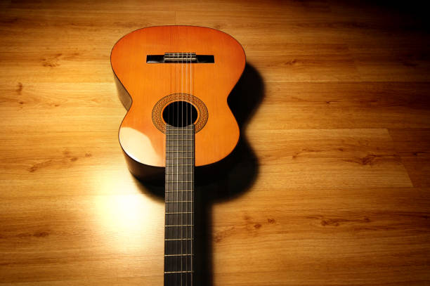 Spanish guitar on wooden floor. Acoustic instrument.