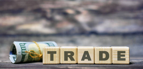 istock Concept - text Trade on wooden light cubes with a cash bill 1208875973