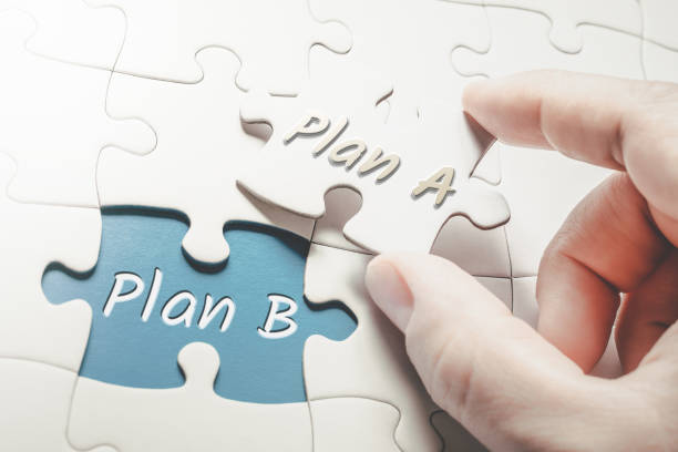 Plan A and Plan B In A Missing Piece Jigsaw Puzzle, Two Fingers Holding Plan A Piece stock photo