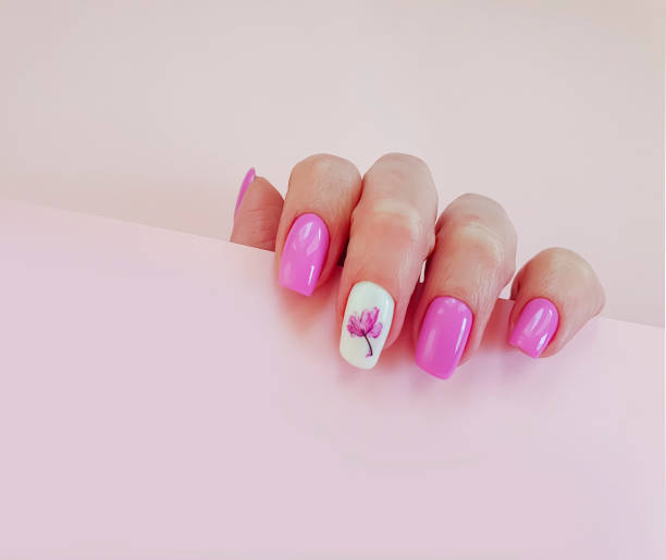 istock female hand beautiful manicure on a colored background 1208879312