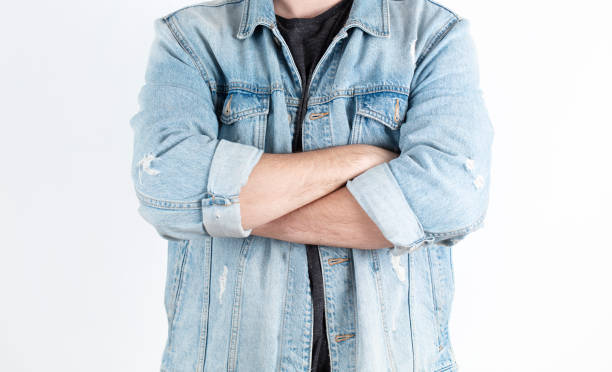 istock Young man with hands folded against white background. successful and confident hand stance. 1208885467