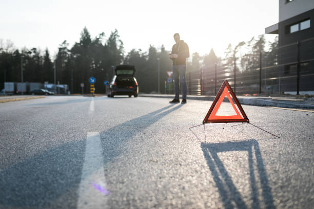 istock Young man calling for help because of a car accident. 1208892390