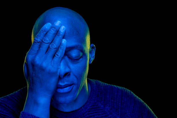istock Black man with hand in eye and the other closed with blue light 1208893690