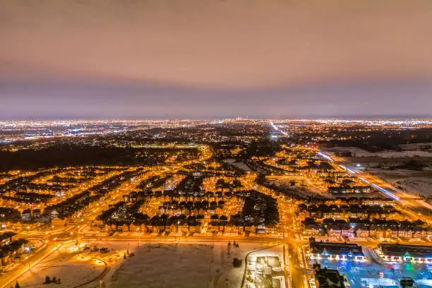 February 2020, Canadian houses and community in winter, at night,  Arial photography, real estate,  drone photography, winter residential, Toronto. mass construction, client satisfaction, customer service. lifestyle. city development, township, Richmond hill, Ontario. sunset, bird view. city bright light, night flight, driving at night, late commute, car light. light pollution, drone, leisure time,