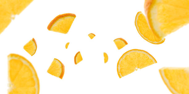 istock Orange background. Citrus fruit tangerine slices falling on white with clipping path. 1208902550