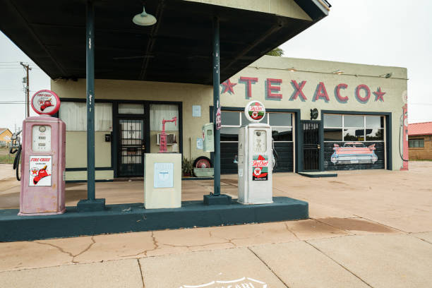 Tucumcari, New Mexico USA - October 4, 2019: Cityscape view of a vintage and closed Americana style Texaco gasoline station with colorful signage along the historic Route Highway 66 that runs through this small rural town located in Quay County in northeast New Mexico.