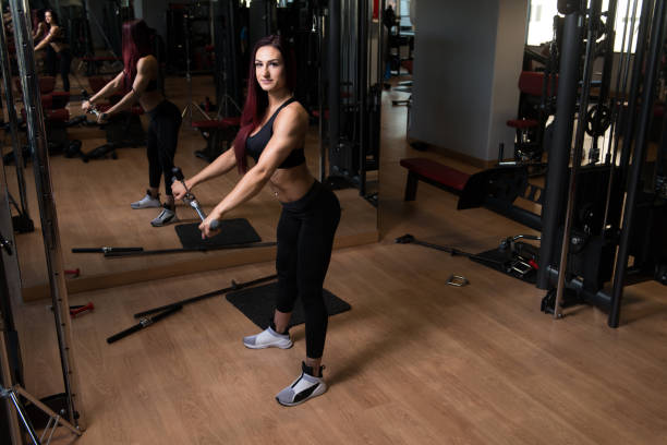 istock Attractive Woman Doing Heavy Weight Exercise For Back 1208909100
