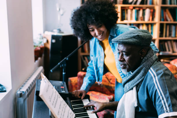 istock Father and daugther playing the piano at home 1208909143