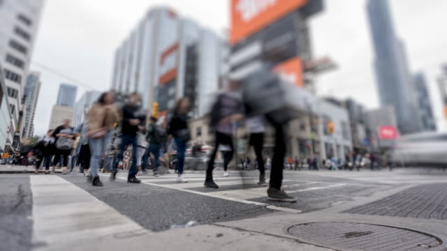 Time lapse of crosswalk at four-way intersection near Dundas Square in Downtown Toronto