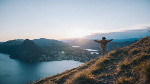 istock Young boy pauses at edge of trail, mountainside 1208913754
