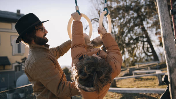 istock Father and son play in urban park setting 1208913765