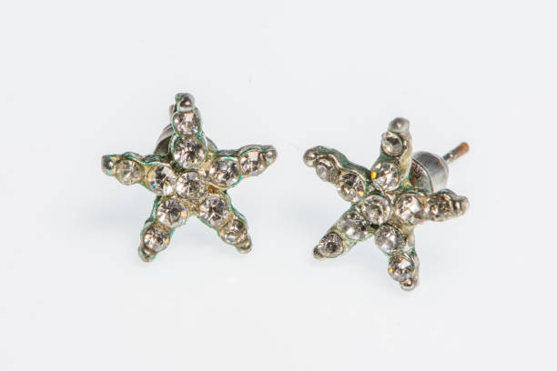 istock Pair of silver earrings with diamonds 1208914434