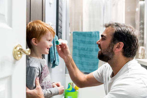 istock Father measuring temperature of his sick boy with infrared thermometer 1208922663