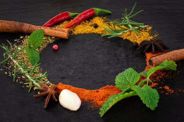 istock Colourful various herbs and spices on dark background 1208933873