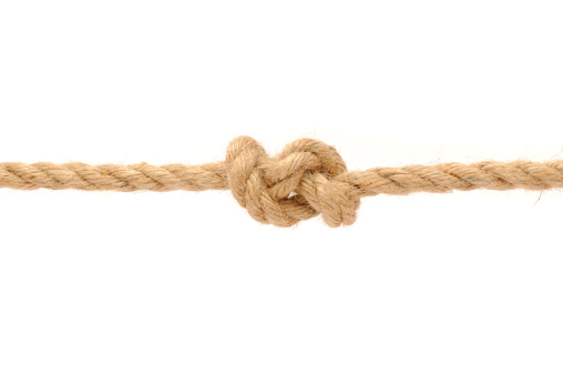 A jute rope with knot on a white background