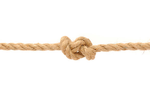 Knotted rope isolated on white A jute rope with knot on a white background lace fastener photos stock pictures, royalty-free photos & images