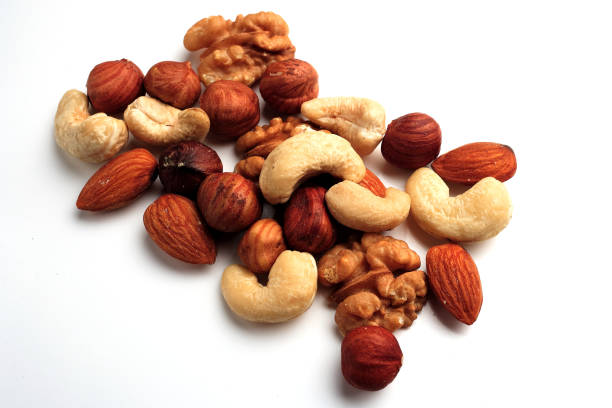 istock A bunch of assorted nuts on a white background. Healthy food and snacks. 1208935001