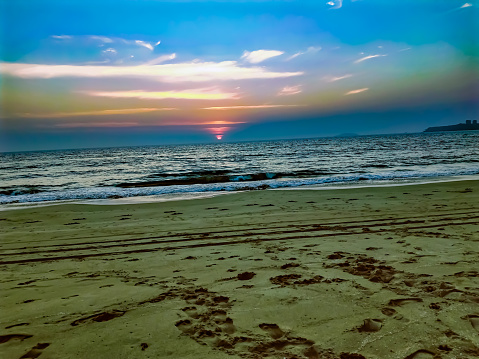 Velsao sea beach or goa sea beach  with horizontal blue sky  waves and sand at sunrise time