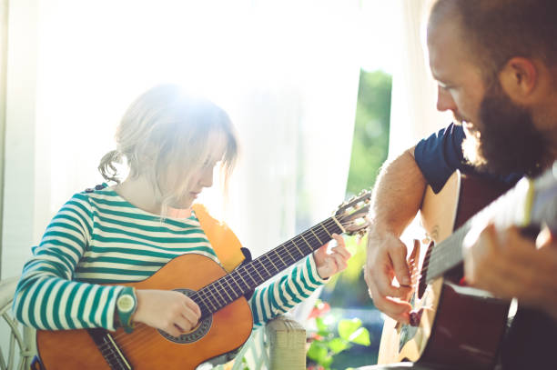 istock Jam session man and child play guitar 1208935892