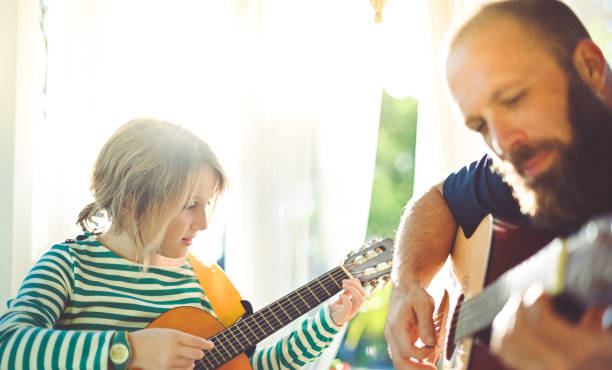 istock Jam session man and child play guitar 1208935909