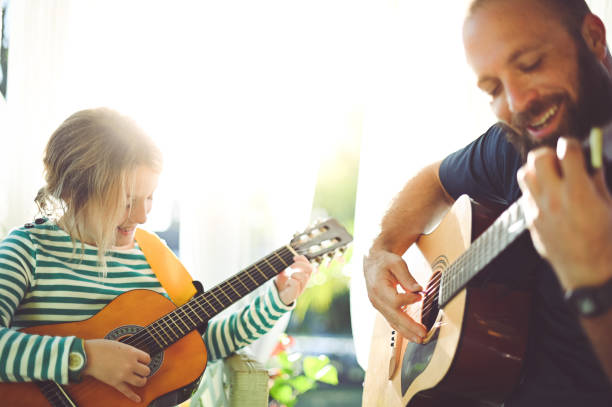 istock Jam session man and child play guitar 1208935936