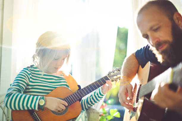 istock Jam session man and child play guitar 1208935971