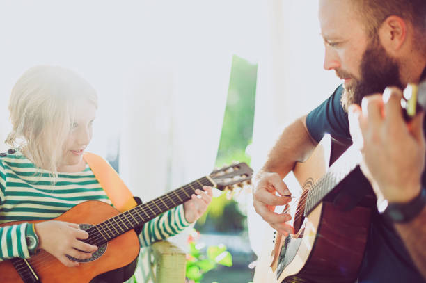 istock Jam session man and child play guitar 1208936027