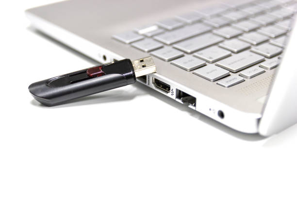 istock flash drive with laptop computer for conncet to USB port plug-in Laptop for transfer and backup business 1208936110