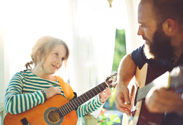 istock Jam session man and child play guitar 1208936653