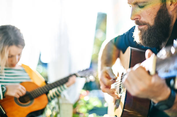 istock Jam session man and child play guitar 1208936656