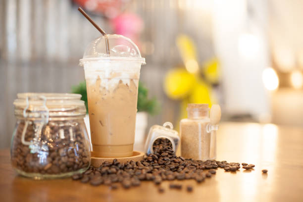 istock Iced drink with coffee beans, Roasted coffee beans in bottles, and spoon. 1208937359