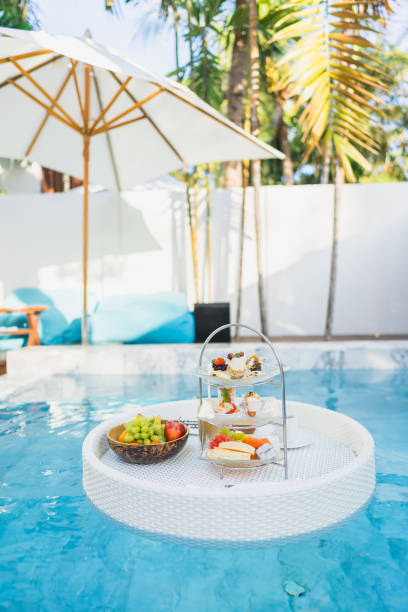 istock Breakfast and afternoon tea set floating around swimming pool 1208940139