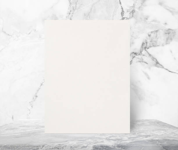 istock Blank Eco textured paper poster on marble stone table top at white marble wall background,Template mock up frame for adding your design. 1208948846