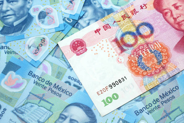 istock A Chinese one hundred yuan note on a background of Mexican peso bills 1208949156